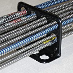 there are many different types of hoses on the table and one is black with red, white and blue stripes