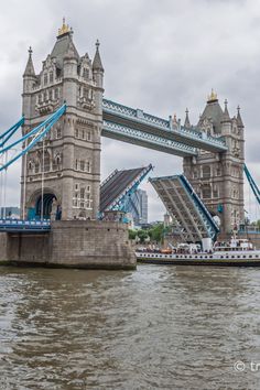 the tower bridge is opened to allow boats to pass under