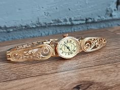 Stunning, vintage USSR Seagull watch in gold. This is one of the first watches in this style (filigree), very high quality made, rare watch. Vintage mechanical women's watch "Chaika" produced by the Uglich Watch Factory (Uglich), founded in 1942. Retro women's vintage watch, mechanical. Seagull with a beautiful dial. The watch is in excellent condition. This is an old production watch. They work well, have been serviced and checked by a professional watchmaker. The elegant Scan "Chaika" wristwatch is equipped with a 17-jewel movement. Bracelet Length: 18.5 cm (7.28 inch) This is a mechanical watch, so wind it every day. Visit my store here: https://odessa13watch.etsy.com If you have any questions for me. I will be happy to answer them. PLEASE NOTE All of our items are vintage and sold AS I Vintage Gold Watch Accessories For Gift, Victorian Gold Watch For Formal Occasions, Gold Engraved Watch Accessories With Round Dial, Victorian Gold Formal Watch, Vintage Gold Watches With Metal Dial, Vintage Yellow Gold Watches As Gifts, Victorian Gold Watch For Weddings, Gold Victorian Watches For Weddings, Heirloom Gold Engraved Watch