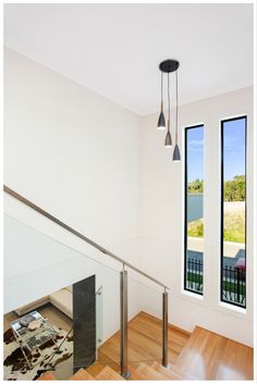 an empty room with two large windows and a railing in front of the glass door