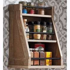 a wooden spice rack with spices on it