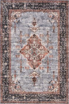 a blue rug with an ornate design on the front and back side, in various colors