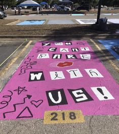 the sidewalk has been decorated with pink and black letters