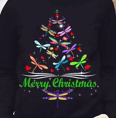 a women's christmas tree with dragonflies on it and the words merry christmas