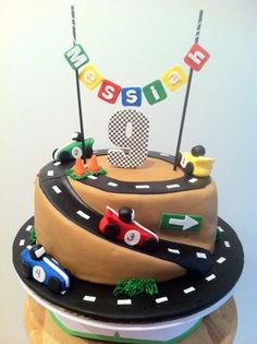 a birthday cake is decorated with cars and the number nine on it's side