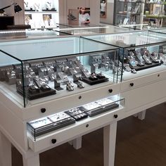 a display case filled with lots of different types of watches and watch parts in glass cases