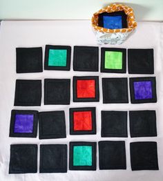 a white table topped with lots of different colored squares