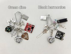 two keychains with different types of items attached to them and the words green dice black harmonica