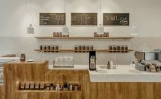 a coffee shop with wooden counter tops and shelves