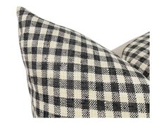 a black and white checkered pillow on a white background