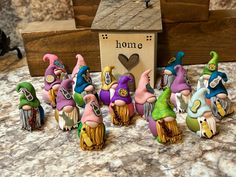 a group of gnome figurines sitting on top of a counter next to a sign