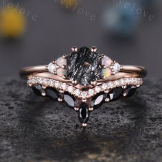 a close up view of an engagement ring with black and white stones on it, set in