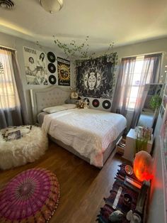 a bedroom with two beds and lots of pictures on the wall above it, along with other decorations