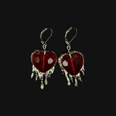 Handmade earrings with brilliant red crystal hearts and soft solder details. Inspired by the heavily encased jewels in metalwork of the Middle Ages, these reference the motif of the bleeding heart, and popular jewelry styles of the period. Hypoallergenic silver plated french earring hooks Made to order; will be unique and vary from product photo Pierced Metal Heart Pendant Jewelry, Pierced Heart Pendant Jewelry, Heart Pendant Sterling Silver Jewelry For Party, Sterling Silver Heart Pendant For Party, Metal Heart Pendant Jewelry With Matching Earrings, Metal Jewelry With Matching Heart Pendant Earrings, Heart Pendant Jewelry With Matching Earrings, Heart Pendant Jewelry Set With Matching Earrings, Silver Gothic Earrings For Valentine's Day