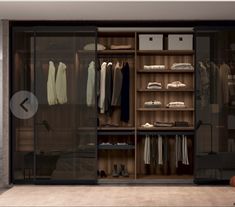 an image of a walk in closet with clothes