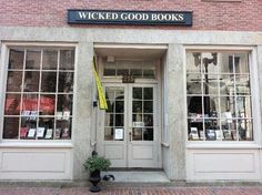 the front entrance to a book store with two large windows