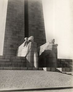 an old black and white photo of two statues