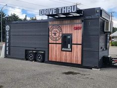 a black and brown building with a sign that says drive thru on the side of it