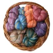 several skeins of yarn in a wicker basket on a white background,