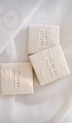 three white soap bars with numbers on them