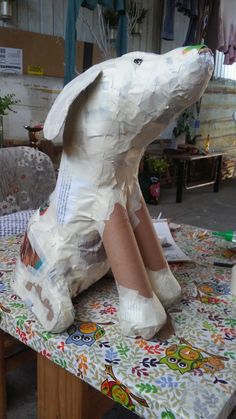 a paper mache dog sitting on top of a table