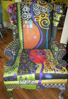 an upholstered chair with colorful designs on it