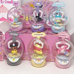 some toys are sitting on top of a pink display case with other items in it