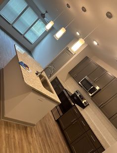 an overhead view of a kitchen with stainless steel appliances and wood flooring on the walls