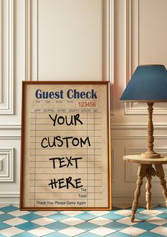 a sign that says guest check next to a small table with a lamp on it