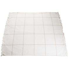 a white blanket with fringes on the edges and a light brown checkerboard pattern