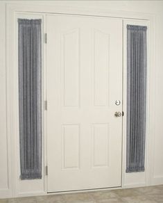 a white door with curtains hanging on it's side