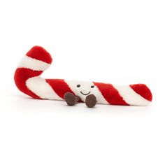 a red and white striped stuffed animal laying on top of it's back legs