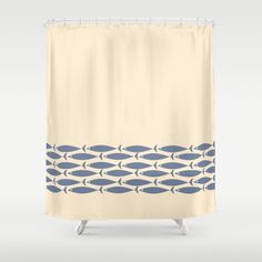 a shower curtain with blue fish on it