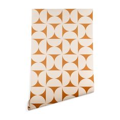 an orange and white geometric wallpaper with circles on the bottom, in various sizes