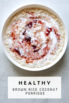 a bowl of oatmeal with strawberries in it and the words healthy brown rice coconut porridge