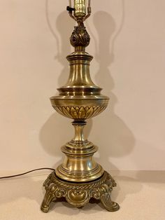 an antique brass lamp on a white background