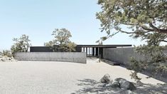 an empty parking lot surrounded by rocks and trees