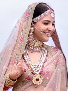 a woman wearing a bridal outfit and jewelry