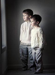 two young boys standing next to each other