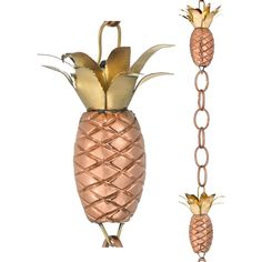 two metal pineapples hanging from chains on a white background, one with gold leaves