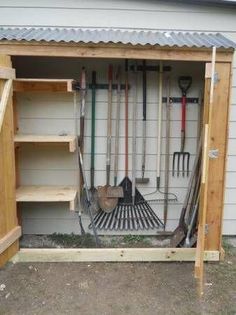 an outdoor storage shed with gardening tools in it