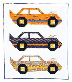 three paper cars on a quilted wall hanging in front of a white background with blue trim