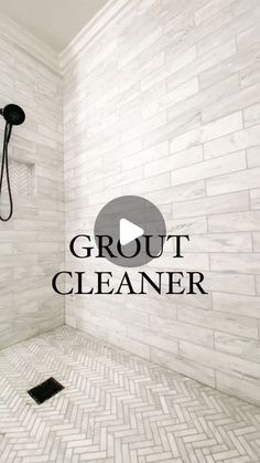 a walk in shower sitting next to a white tiled wall with the words grout cleaner on it