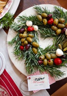 a plate topped with olives and cheese on top of a table