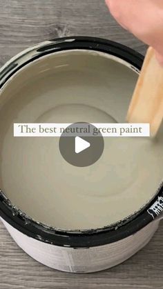 someone is painting the inside of a bucket