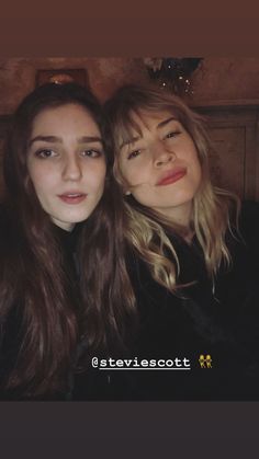 two young women are posing for the camera with their heads close to one another and smiling