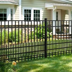 a black metal fence in front of a house