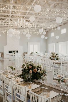 the tables are set with white chairs and place settings for an elegant dinner or reception