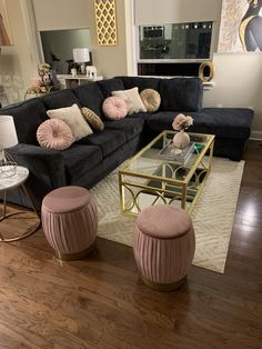 a living room filled with lots of furniture and decor on top of a hard wood floor