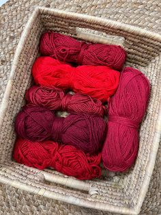 several skeins of red yarn in a wicker basket